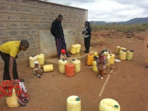 Collecting water from the school bore-hole. Each container is 20L (20Kgms) and may be carried up to 5 miles.