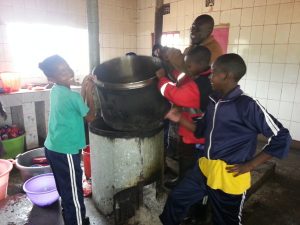 Helping in the school kitchen.