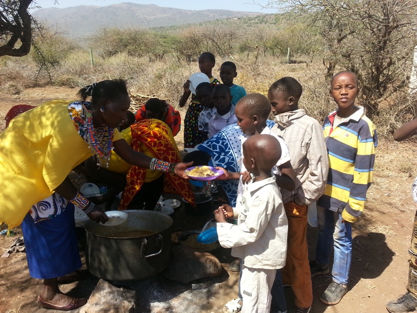 Feeding the children at the ceremony. They are fed last.